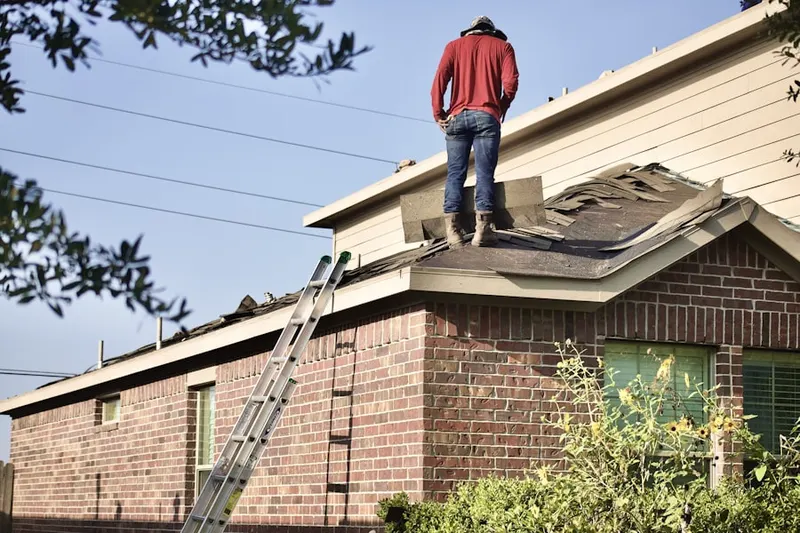 Professional roofer working on a residential roof in White Settlement